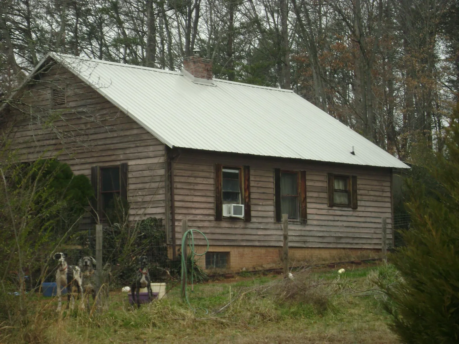 White metal roof on an old wood sided farmhouse, from a Metal Roof Installation job in Riesel